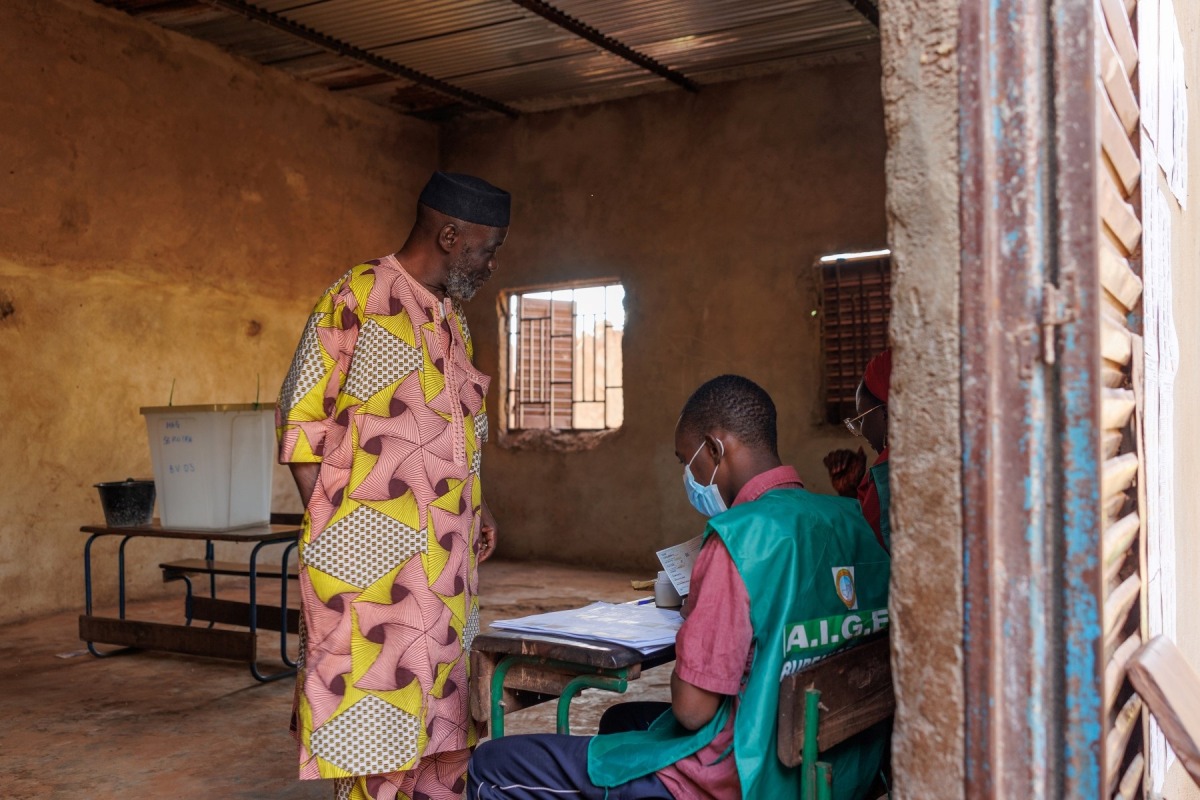 A voter registers to vote as polls open during Mali’s referendum in Bamako on June 18, 2023. 