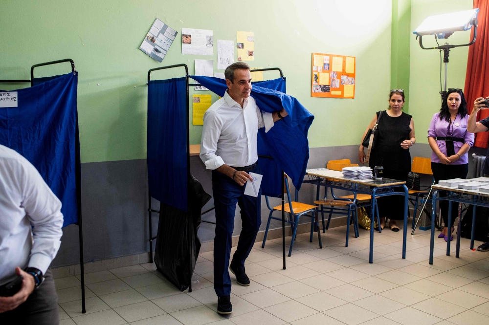 Greek former prime minister and leader of Greece's conservative party New Democracy, Kyriakos Mitsotakis leaves a voting booth at a polling station during the general election in Athens on June 25, 2023. (Photo by ANGELOS TZORTZINIS / AFP)