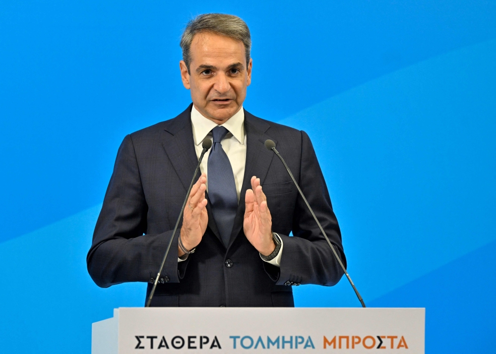 Greek ex-prime minister Kyriakos Mitsotakis, and leader of the New Democracy party, gives his speech after clinching a landslide victory in the second round of the general elections, at the party headquarters in Athens on June 25, 2023. (Photo by Louisa Gouliamaki / AFP)