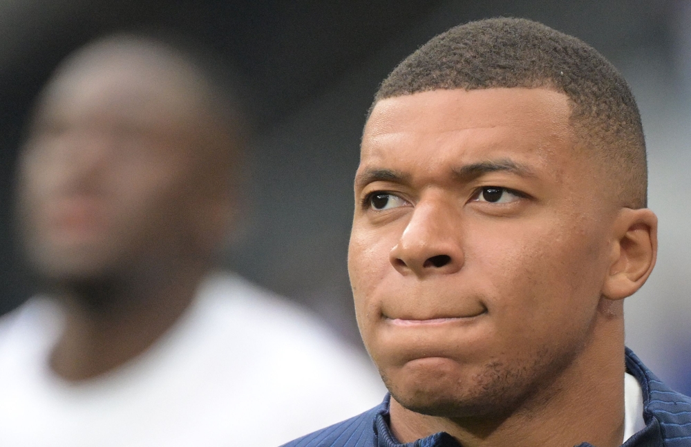 France's forward Kylian Mbappe looks on as he warms up prior to the UEFA Euro 2024 group B qualification football match between France and Greece at the Stade de France in Saint-Denis, in the northern outskirts of Paris, on June 19, 2023. (Photo by Alain JOCARD / AFP)