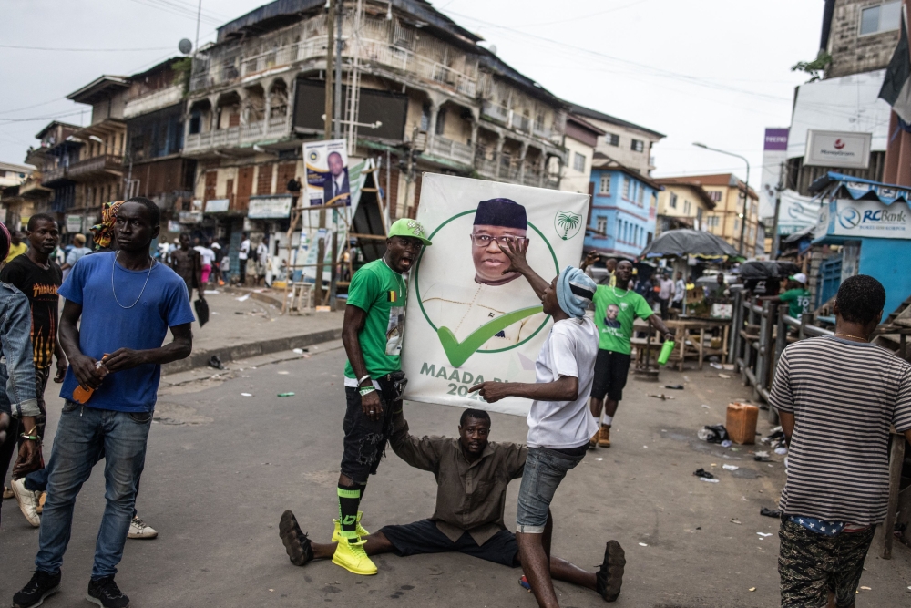 Supporters of the President of Sierra Leone and Leader of Sierra Leone People party (SLPP), Julius Maada Bio, celebrate in the streets following his re-election in Freetown in June 27, 2023. (Photo by JOHN WESSELS / AFP)