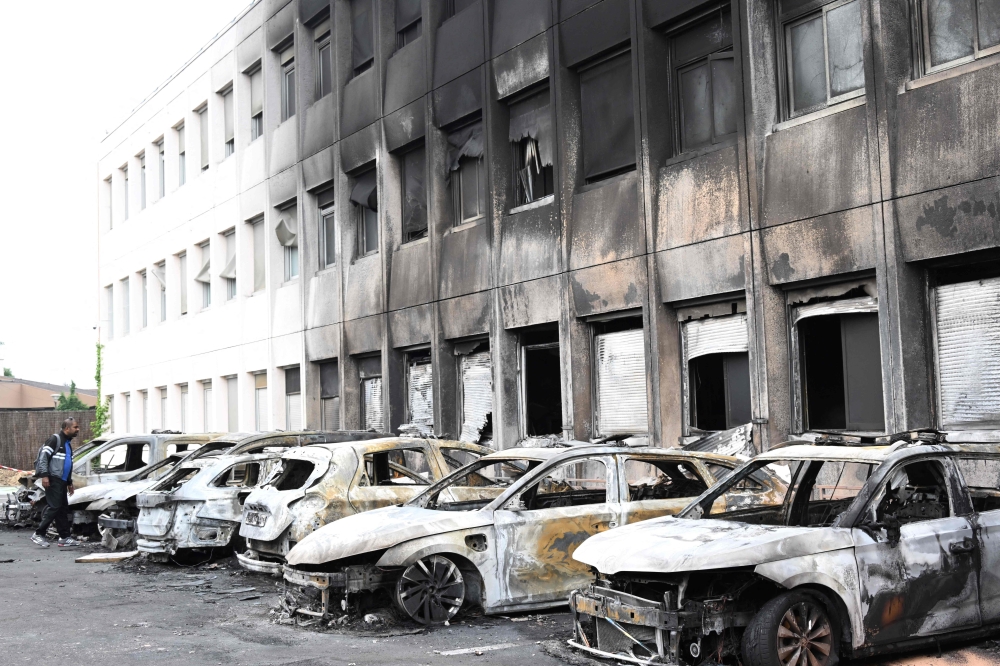 Seven burnt out vehicles are seen outside the municipal police building following violence in Neuilly-sur-Marne on June 29, 2023, following riots two days after a 17-year-old boy was shot in the chest by police at point-blank range in Nanterre, a western suburb of Paris. (Photo by Bertrand GUAY / AFP)
