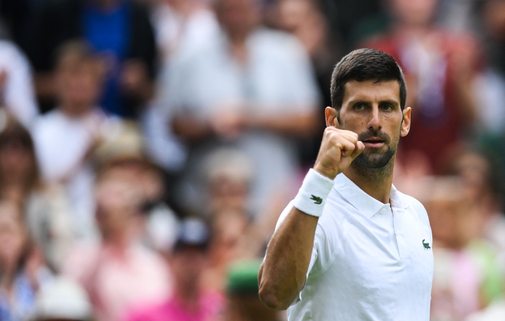 Serbia's Novak Djokovic celebrates after winning against Argentina's Pedro Cachin during their men's singles tennis match on the first day of the 2023 Wimbledon Championships at The All England Tennis Club in Wimbledon, southwest London, on July 3, 2023. (Photo by Daniel LEAL / AFP)