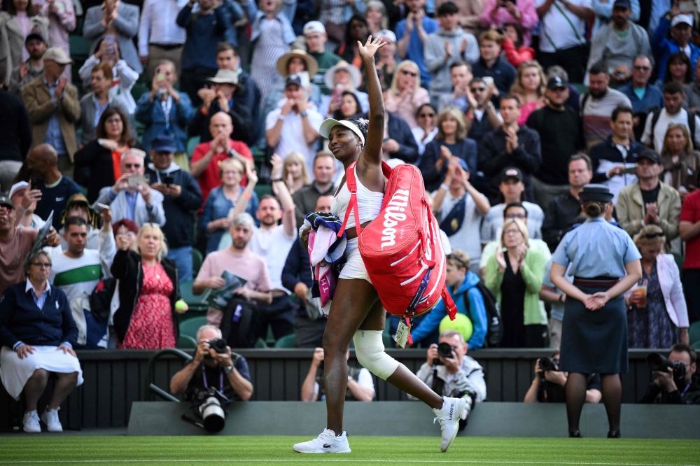 US player Venus Williams waves to the audience as she leaves the court following her defeat against Ukraine's Elina Svitolina at the end of their women's singles tennis match on the first day of the 2023 Wimbledon Championships at The All England Tennis Club in Wimbledon, southwest London, on July 3, 2023. (Photo by Daniel Leal / AFP)