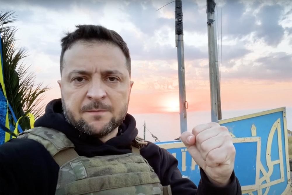 In this handout video grab taken from footage released by the Ukrainian Presidency on July 8, 2023, Ukraine's President Volodymyr Zelensky pumps his fist as he visits the Snake Island (Zmiinyi Island), Odesa region. 