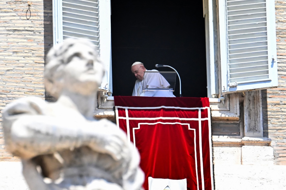 Pope Francis leaves after he addressed the crowd from the window of the apostolic palace overlooking St.Peter's square during his Angelus prayer at the Vatican on July 9, 2023. (Photo by Alberto PIZZOLI / AFP)
