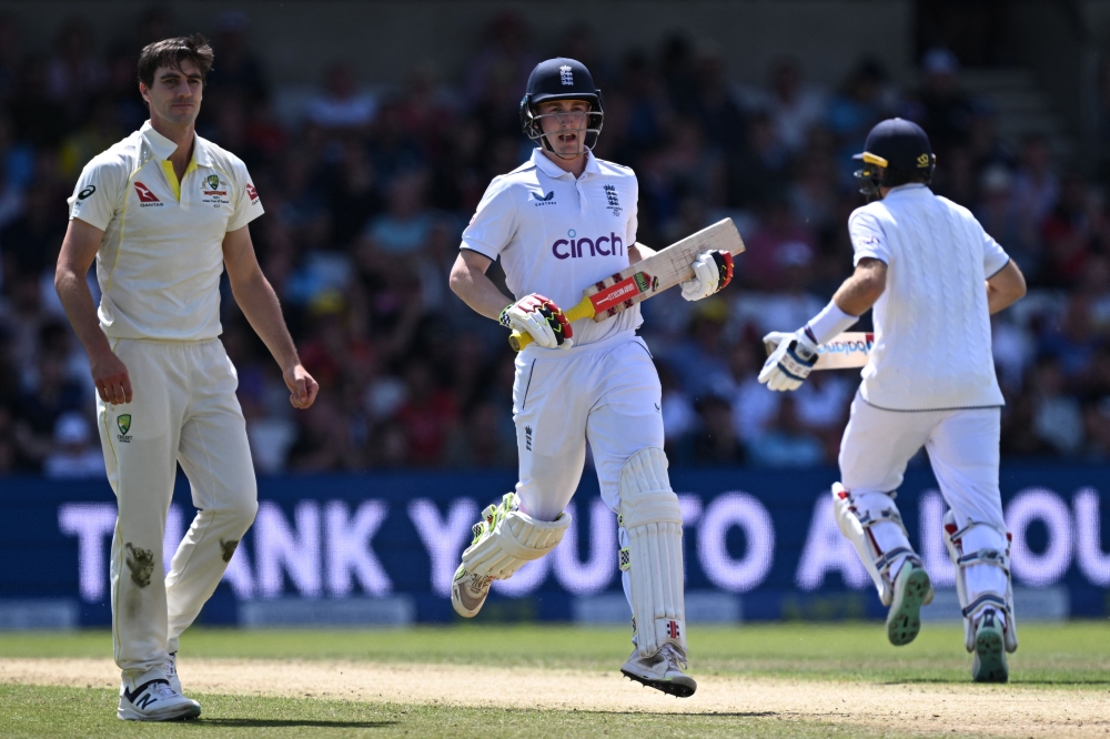 England's Harry Brook (C) and England's Joe Root (R) take a run on day four of the third Ashes cricket Test match between England and Australia at Headingley cricket ground in Leeds, northern England on July 9, 2023. (Photo by Paul ELLIS / AFP)