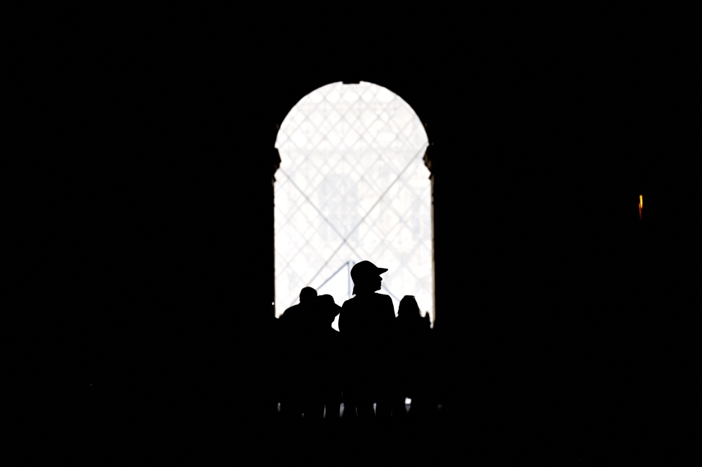Tourists visit the Louvre Museum in Paris, on July 9, 2023. Photo by Sergei GAPON / AFP