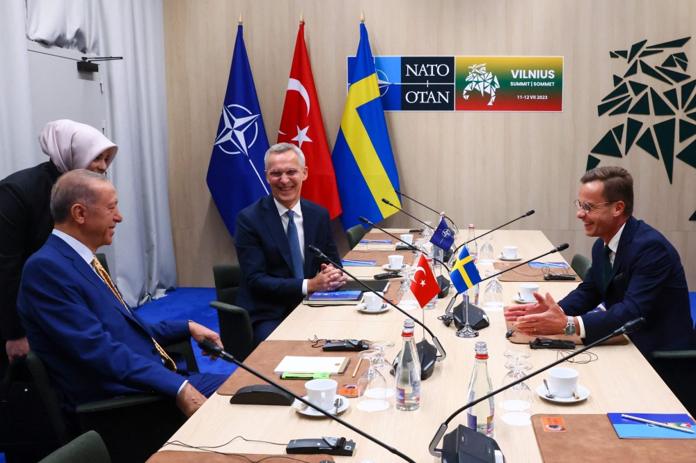 NATO Secretary-General Jens Stoltenberg (top center), Turkish President Tayyip Erdogan and Swedish Prime Minister Ulf Kristersson (right) during a meeting, on the eve of a NATO summit, in Vilnius on July 10, 2023. (Photo by Yves Herman / AFP)