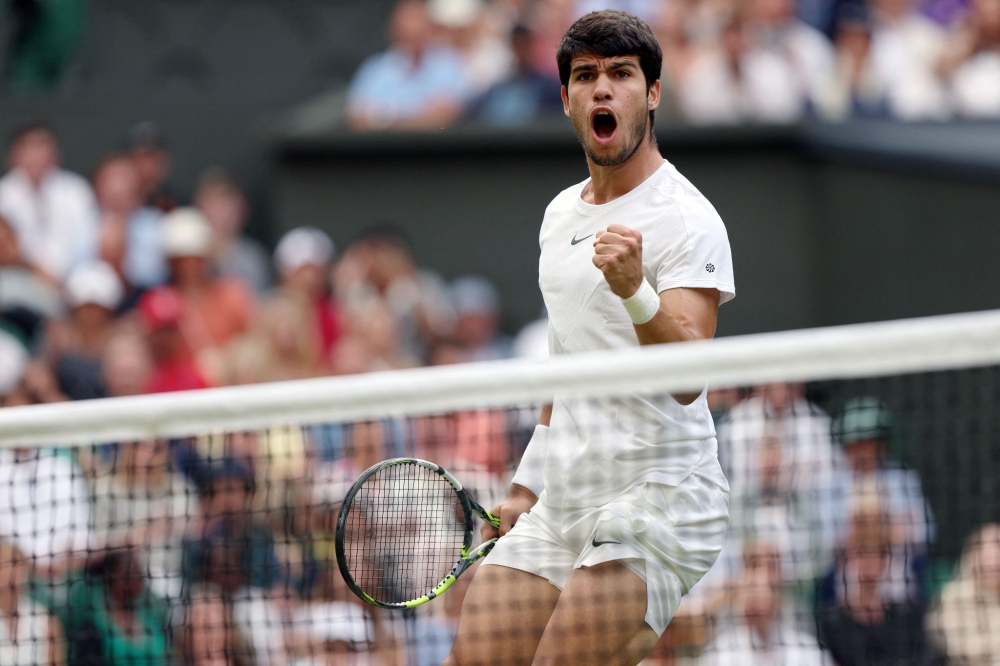Spain's Carlos Alcaraz reacts as he plays against Italy's Matteo Berrettini during their men's singles tennis match on the eighth day of the 2023 Wimbledon Championships at The All England Tennis Club in Wimbledon, southwest London, on July 10, 2023. Photo by Adrian DENNIS / AFP