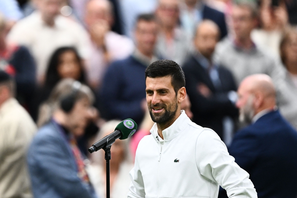 Serbia's Novak Djokovic speaks during an interview after winning against Italy's Jannik Sinner during their men's singles semi-finals tennis match on the twelfth day of the 2023 Wimbledon Championships at The All England Lawn Tennis Club in Wimbledon, southwest London, on July 14, 2023. (Photo by SEBASTIEN BOZON / AFP) /