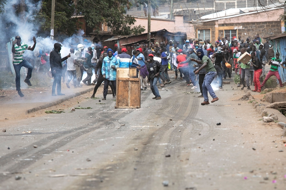 Protestors clash with Kenyan police officers during anti-government protests in Nairobi on July 19, 2023. Kenya braced on July 19, 2023 for a new round of protests despite the government warning it would not tolerate further unrest after earlier demonstrations turned violent with more than a dozen people killed. (Photo by Tony KARUMBA / AFP)