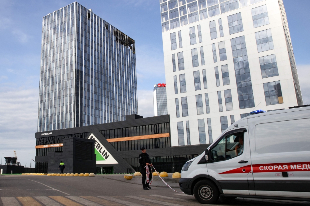 An ambulance drives in front of a damaged business centre on Likhacheva Street after a reported drone attack in Moscow on July 24, 2023. (Photo by Stringer / AFP)