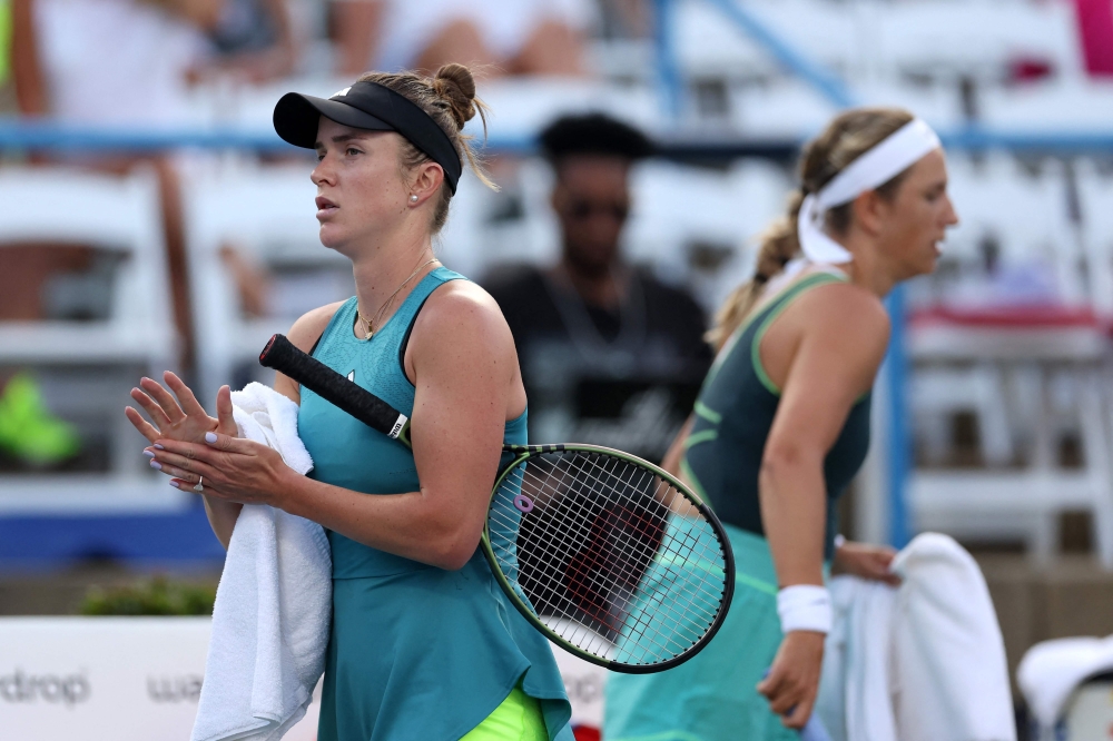 Elina Svitolina of Ukraine (L) walks past Victoria Azarenka before the start of their match during Day 3 of the Mubadala Citi DC Open at Rock Creek Tennis Center on July 31, 2023 in Washington, DC. Rob Carr/Getty Images/AFP 