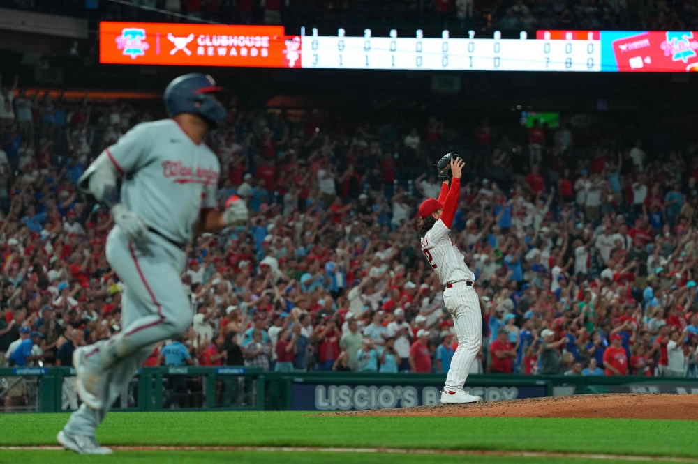 Michael Lorenzen #22 of the Philadelphia Phillies reacts in front of Dominic Smith #22 of the Washington Nationals after throwing no-hitter at Citizens Bank Park on August 9, 2023 in Philadelphia, Pennsylvania. (Photo by Mitchell Leff / GETTY IMAGES NORTH AMERICA / Getty Images via AFP)
