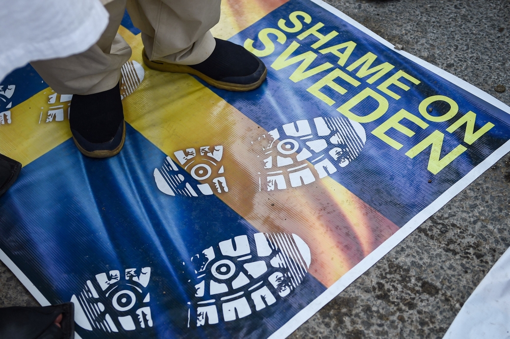 File Photo: People take part in a demonstration in Karachi on July 2, 2023, as they protest against the burning of the Holy Quran outside a Stockholm Mosque that outraged Muslims around the world. (Photo by Rizwan Tabassum / AFP)