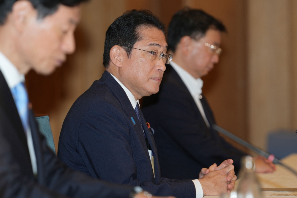 Japan's Prime Minister Fumio Kishida (C) reacts during a meeting with Masanobu Sakamoto, head of the National Federation of Fisheries Cooperative Associations, and other representatives the prime minister office in Tokyo on August 21, 2023. Photo by ZHANG Xiaoyu / POOL / AFP