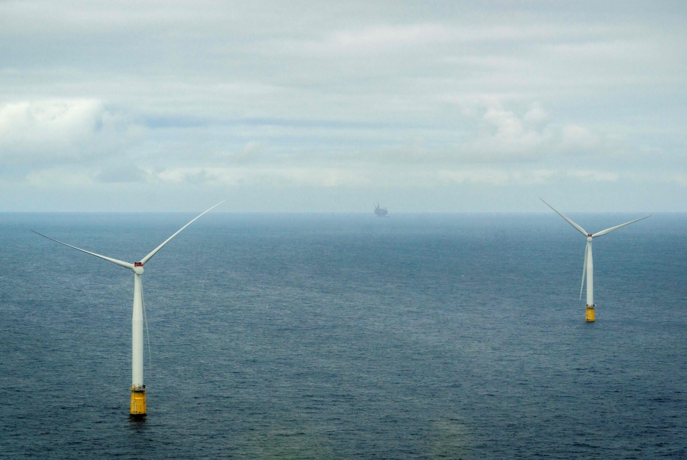 A view out of an aircraft shows offshore wind engines during a flight of Norway's Crown Prince and Norway's Prime Minister to attend the inauguration of the Hywind Tampen floating offshore wind farm, situated between energy company Equinor's oil and gas fields Snorre and Gullfaks in the Norwegian North Sea off the coast of Bergen on August 23, 2023. Photo by Ole Berg-Rusten / NTB / AFP