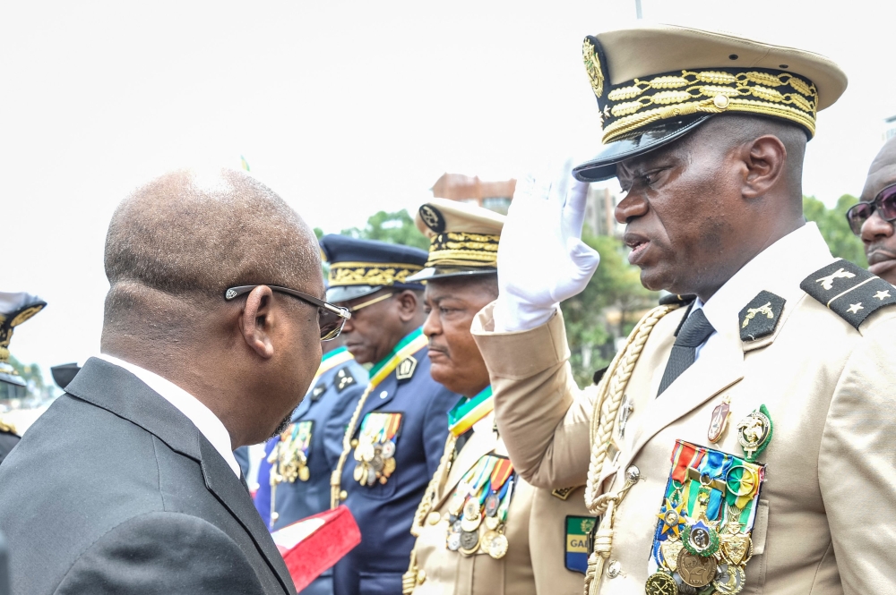 File photo: Head of Gabon's elite Republican Guard, General Brice Oligui Nguema (right), is decorated by Gabon Prime Minister Alain Claude Bilie Bie Nze (left) in Libreville on August 16, 2023 during celebrations ahead of Gabon Independence day celebrated on August 17, 2023. (Photo by AFP)