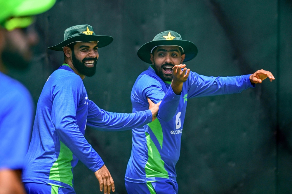 Pakistan's captain Babar Azam (R) and Shadab Khan gesture during a practice session at the R. Premadasa Stadium in Colombo on September 9, 2023. (Photo by Ishara S. KODIKARA / AFP)