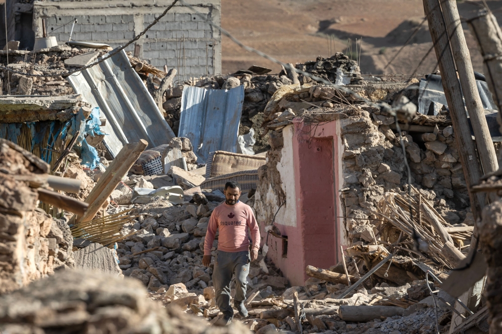A man walks past destroyed houses after an earthquake in the mountain village of Tafeghaghte, southwest of the city of Marrakesh, on September 9, 2023. Photo by FADEL SENNA / AFP