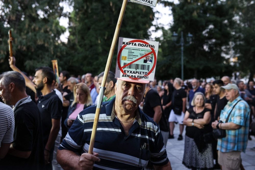 Greeks demonstrate against the issuing of the new biometric identity cards that the government has decided to put into circulation, in Athens on September 10, 2023.  (Photo by Aris Oikonomou / AFP)