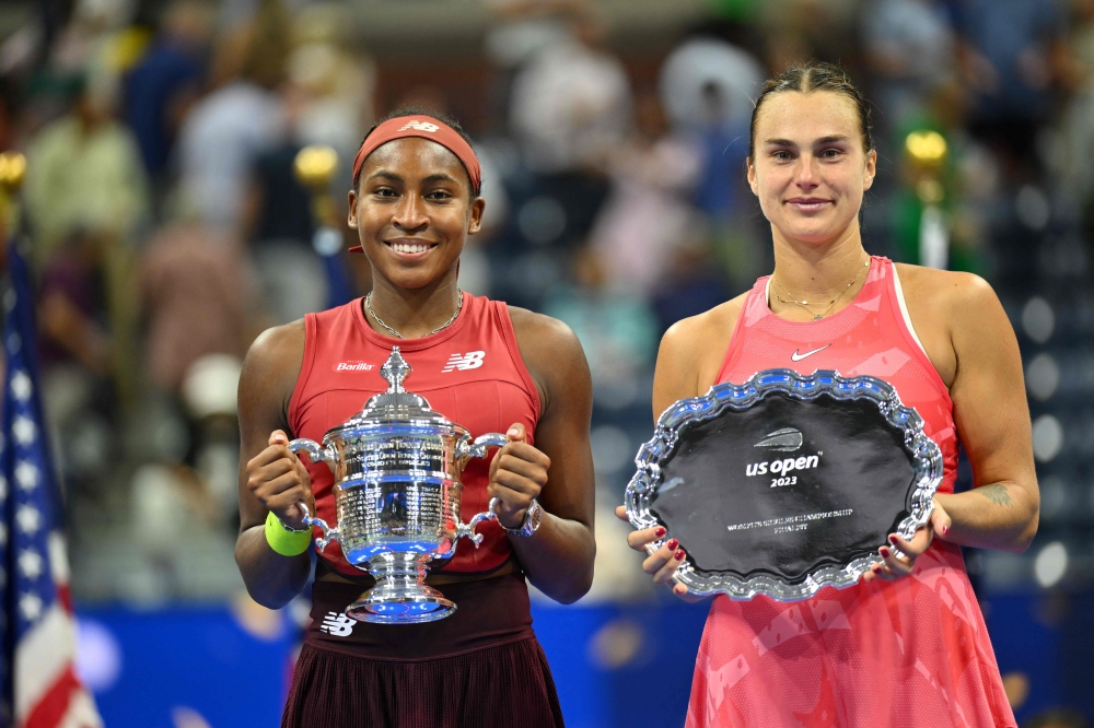 USA's Coco Gauff and Belarus's Aryna Sabalenka hold their trophies after Gauff won the US Open tennis tournament women's singles final match at the USTA Billie Jean King National Tennis Center in New York on September 9, 2023. (Photo by Angela Weiss / AFP)

