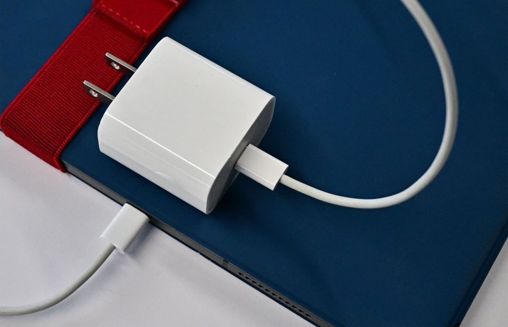 This photo illustration shows a USB-C cable in the port of an Apple iPad on September 11, 2023 in Los Angeles. (Photo by Frederic J Brown / AFP)
