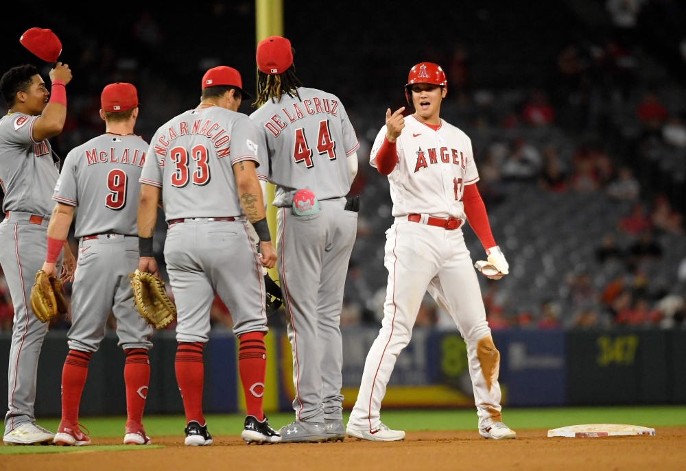File photo: Designated hitter Shohei Ohtani #17 of the Los Angeles Angels is greeted by Cincinnati Reds infielders during a pitching change after Ohtani's double during the fifth of game two of a doubleheader at Angel Stadium of Anaheim on August 23, 2023 in Anaheim, California. Kevork Djansezian/Getty Images/AFP

