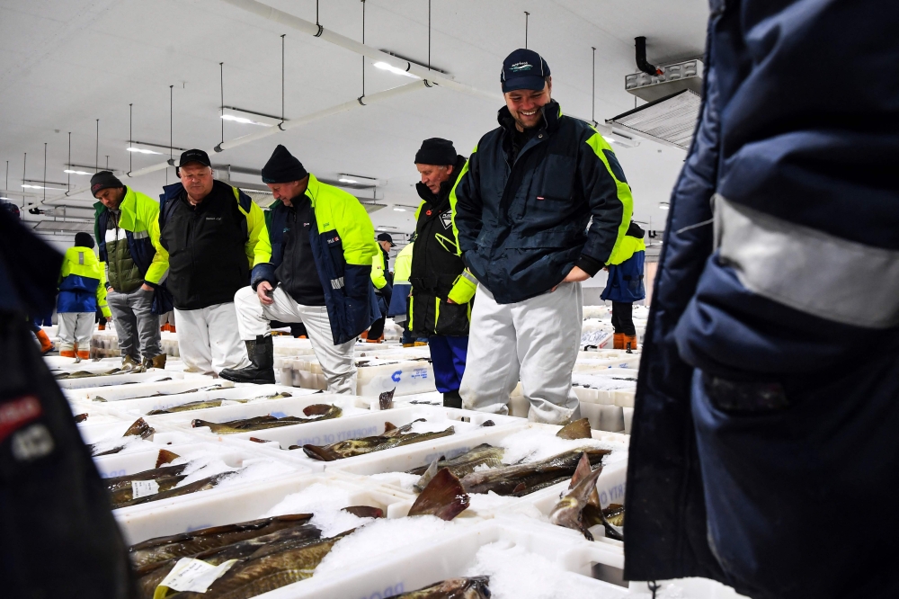 Buyers and workers attend Peterhead Fish Market, on the north east coast of Scotland, on September 7, 2023. (Photo by Andy Buchanan / AFP)