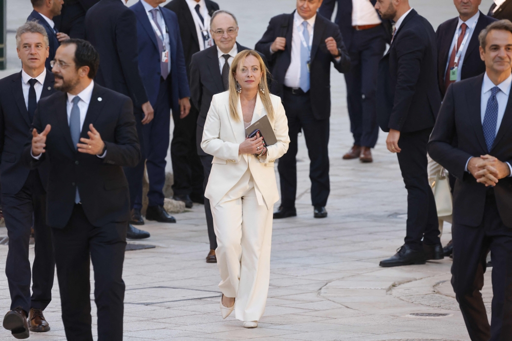 Italian Prime Minister Giorgia Meloni (centre) surrounded by other leaders arrives for a joint press conference at the end of the EU-MED9 summit in Malta on September 29, 2023. (Photo by Ludovic Marin / AFP)
