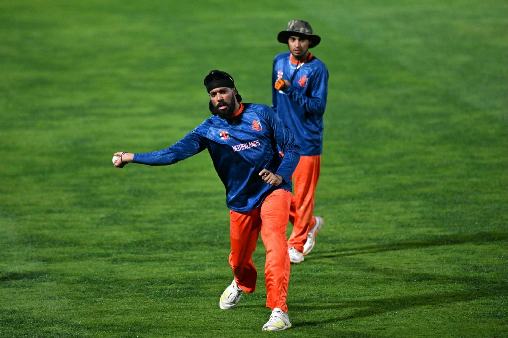 Netherlands’ Vikramjit Singh (L) and Shariz Ahmad attend a practice session on the eve of their 2023 ICC Men's Cricket World Cup one-day international (ODI) match against South Africa at the Himachal Pradesh Cricket Association Stadium in Dharamsala on October 16, 2023. (Photo by Money SHARMA / AFP