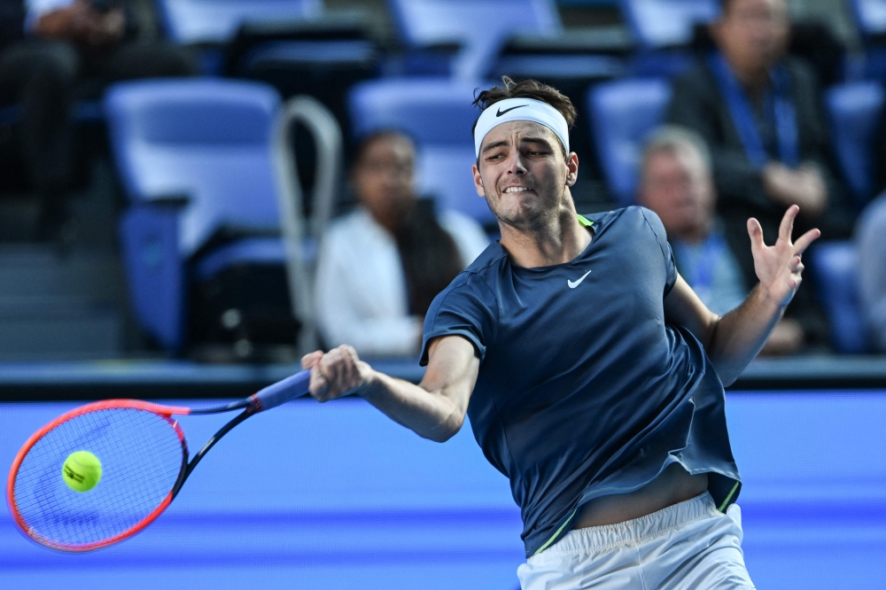 Taylor Fritz of the US hits a return against Cameron Norrie of Britain during their men's singles match on day two of the ATP Japan Open tennis tournament in Tokyo on October 17, 2023.Photo by Richard A. Brooks / AFP