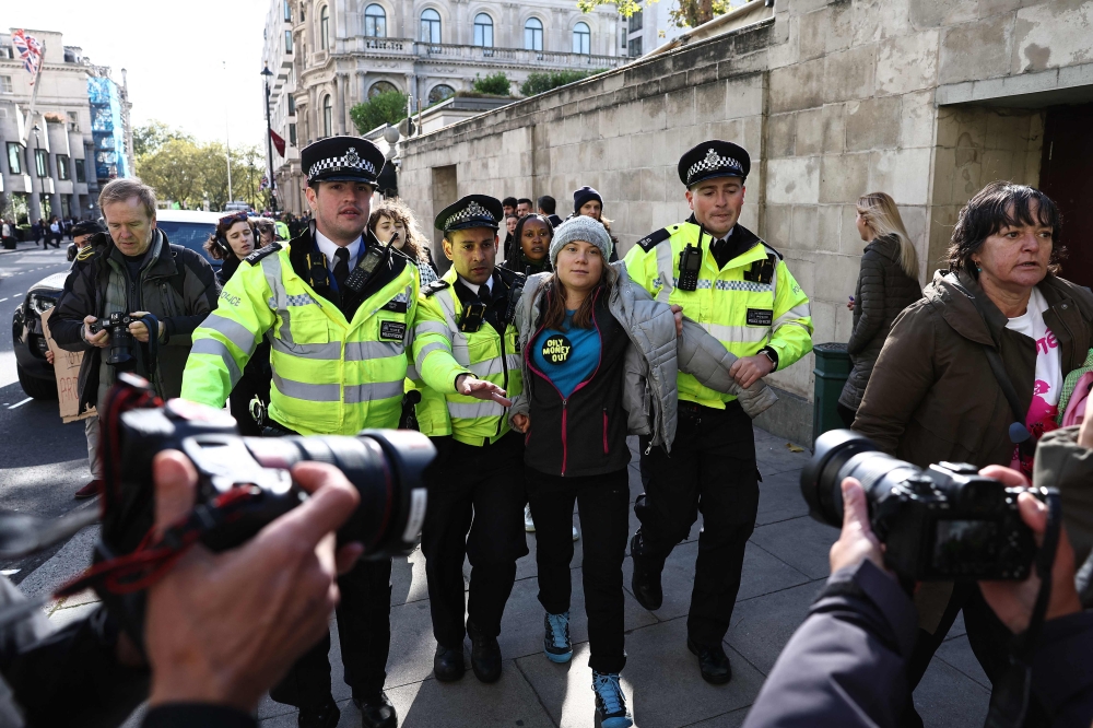 Swedish climate activist Greta Thunberg is arrested by police outside the InterContinental London Park Lane during the 