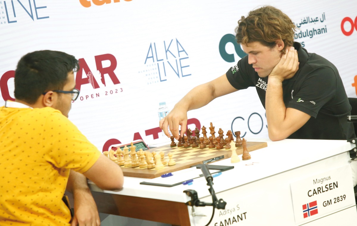 Magnus Carlsen (right) competes against Aditya Samanth.