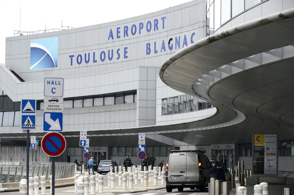 (Files) Soldiers patrol at Toulouse Blagnac Airport in Toulouse, on November 14, 2015. (Photo by REMY GABALDA / AFP)