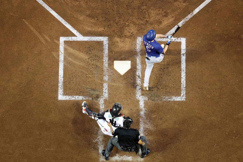 Corey Seager #5 of the Texas Rangers hits a home run in the third inning against the Arizona Diamondbacks during Game Three of the World Series at Chase Field on October 30, 2023 in Phoenix, Arizona. (Photo by Christian Petersen / GETTY IMAGES NORTH AMERICA / Getty Images via AFP)
