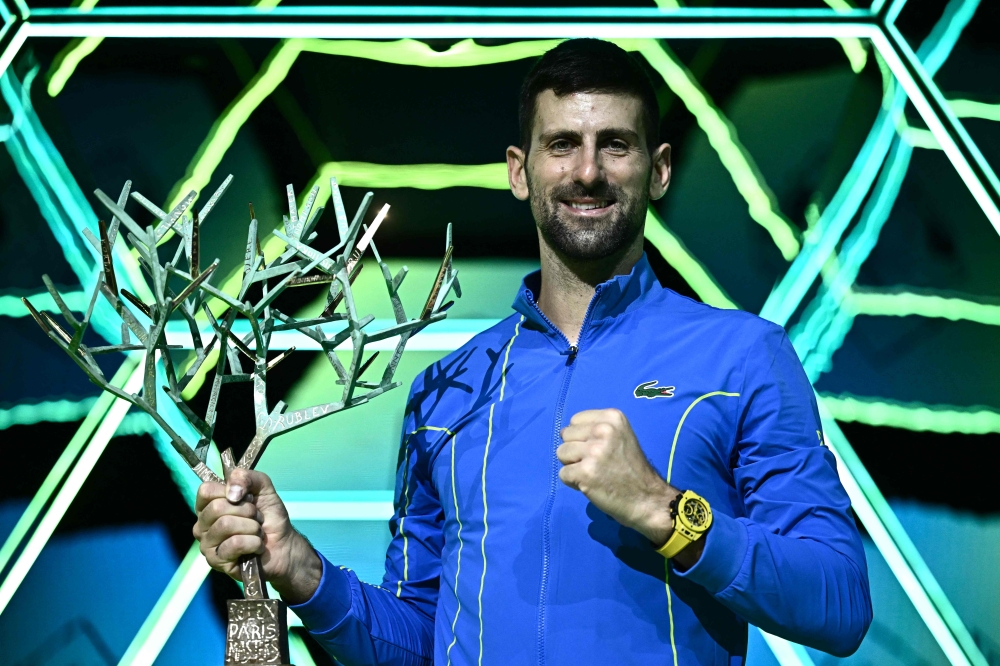 Serbia's Novak Djokovic poses with the trophy after winning the men's singles final match of the Paris ATP Masters 1000 tennis tournament against Bulgaria's Grigor Dimitrov, at the Accor Arena - Palais Omnisports de Paris-Bercy - in Paris on November 5, 2023. (Photo by Julien De Rosa / AFP)