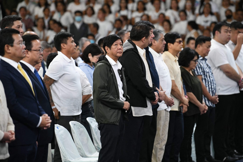 Philippine President Ferdinand Marcos Jr., (C) attends a mass to commemorate the 10th year anniversary of Super Typhoon Haiyan inside a stadium in Tacloban City, Leyte province, central Philippines. (Photo by Ted Aljibe / AFP)
