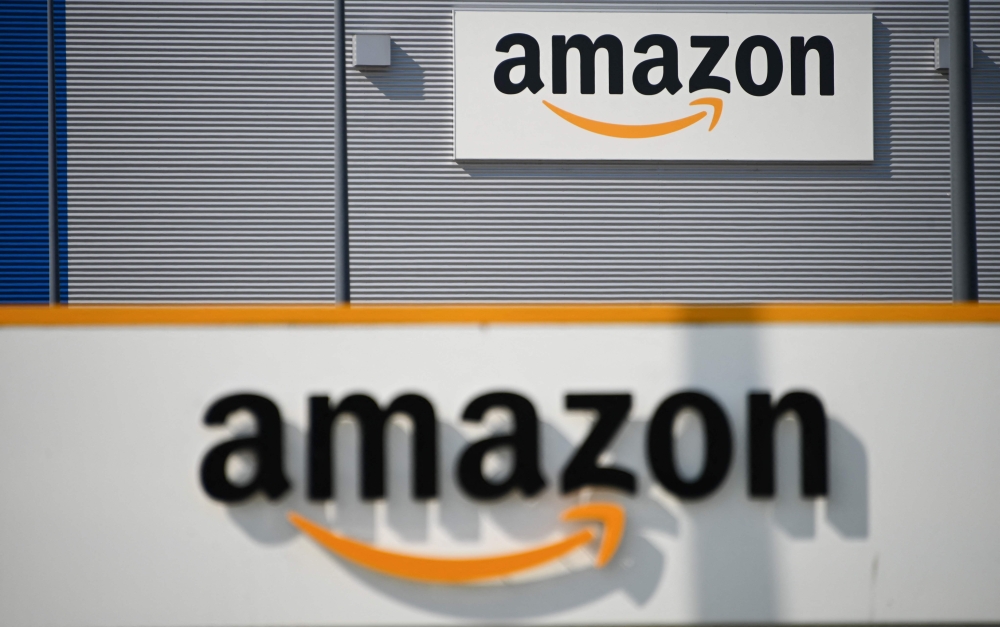 In this file photo taken on April 16, 2020, a picture shows the Amazon logo at the entrance area of the Amazon logistics centre in Lauwin-Planque, northern France, on April 16, 2020. (Photo by DENIS CHARLET / AFP)

