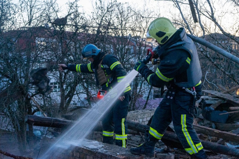 This handout photograph taken and released by Ukrainian Emergency Service on November 25, 2023, shows rescuers working to extinguish a fire at the site of a drone attack in Kyiv (Photo by Handout / Ukrainian Emergency Service / AFP)