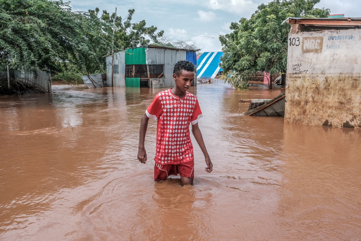 A Somali boy moves through floodwaters in Dolow on November 25, 2023. Photo by Hassan Ali Elmi / AFP