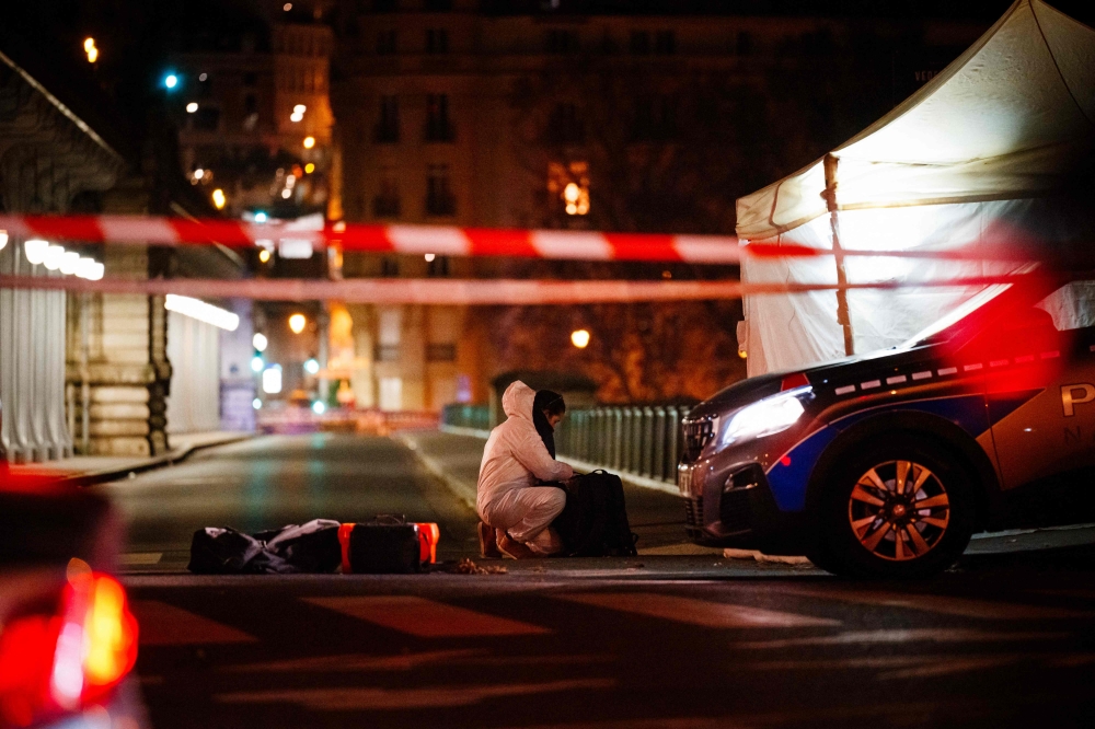 A forensic police officer works at the scene of a stabbing in Paris on December 2, 2023. (Photo by Dimitar Dilkoff / AFP)