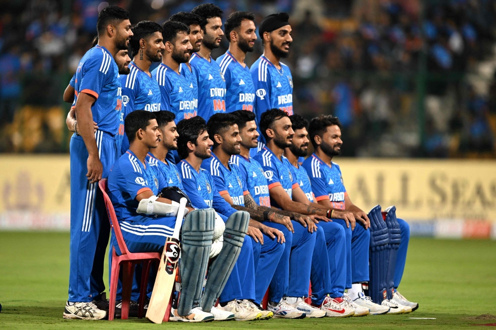India's players pose for a group photograph before the start of the fifth and final Twenty20 international cricket match between India and Australia at the M. Chinnaswamy Stadium in Bengaluru on December 3, 2023. (Photo by Punit PARANJPE / AFP)