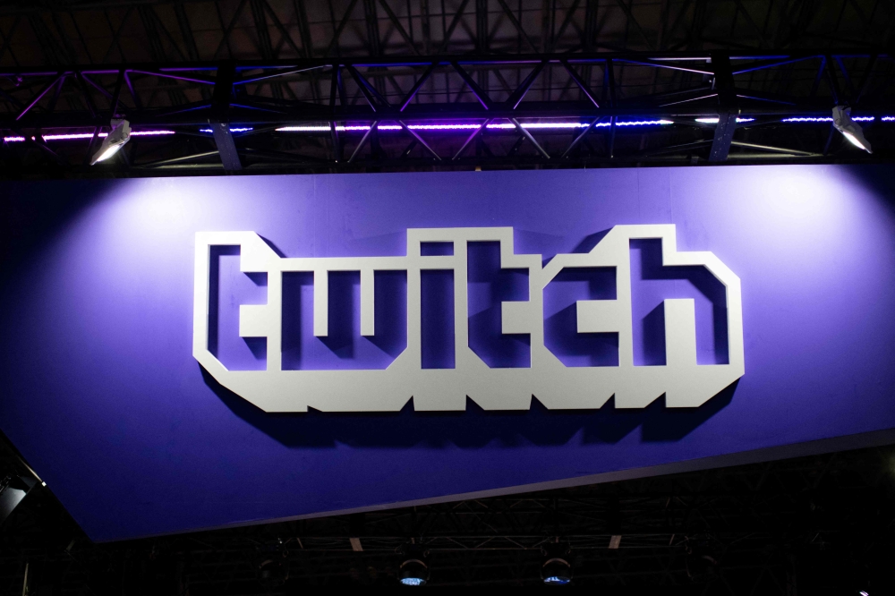 A picture taken at the Tokyo Game Show on September 21, 2018 shows the logo of the VOD and streaming video games company Twitch. Photo by Martin BUREAU / AFP