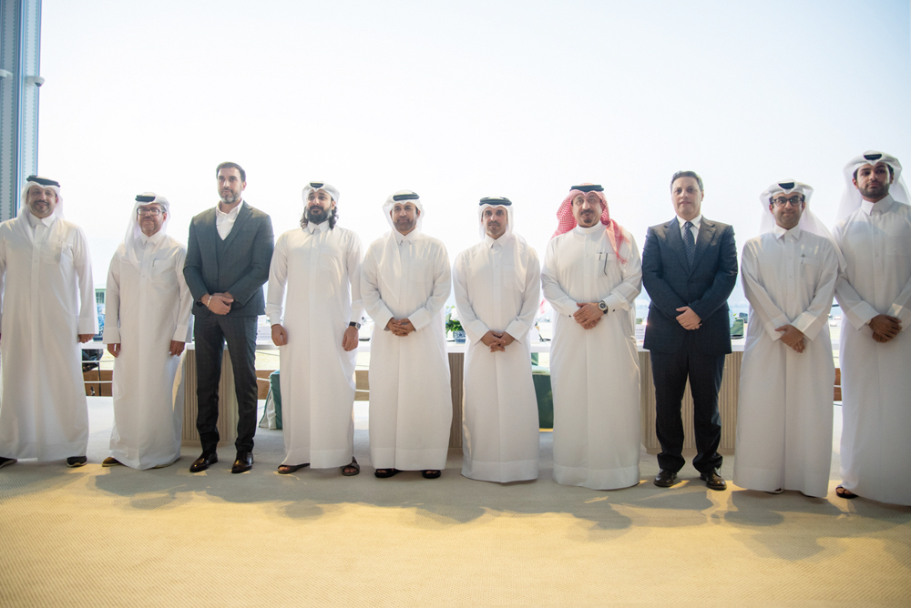 Deputy CEO Business Support, Services & Human Resources at Ahlibank, Mohamed Mousa Al Namla along with other officials poses for a picture.