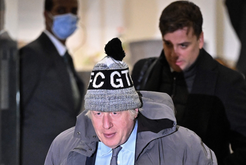 Britain's former Prime Minister Boris Johnson (C) leaves after giving evidence at the UK Covid-19 Inquiry, in west London, on December 6, 2023. Photo by Ben Stansall / AFP