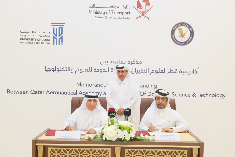 Minister of Transport H E Jassim Saif Ahmed Al Sulaiti looks on as QAA Director-General Sheikh Jabor bin Hamad Al Thani (right) and UDST President Dr. Salem Al Naemi sign a memorandum of understanding yesterday. 