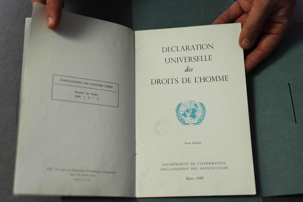 This photograph taken on December 9, 2023, shows a document from the Department of Information of the United Nations, dated March 1949, bearing the French text of the 