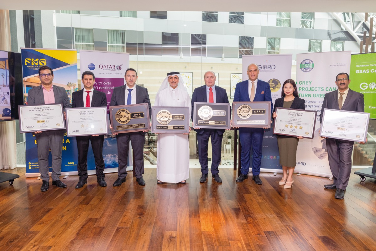 Qatar Airways officials showing off the recognition from Gulf Organisation for Research and Development .